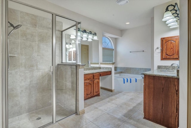 bathroom with a stall shower, tile patterned flooring, vanity, and a bath