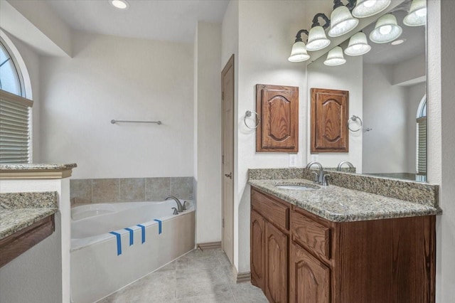 bathroom featuring a bath, tile patterned flooring, and vanity