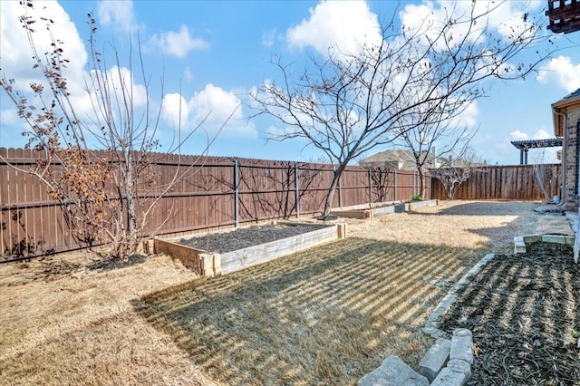 view of yard with a fenced backyard and a garden