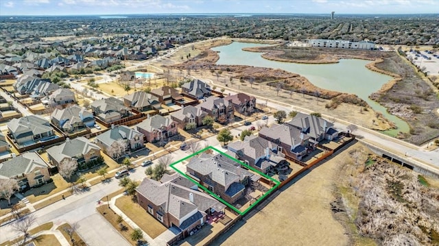 birds eye view of property with a water view and a residential view