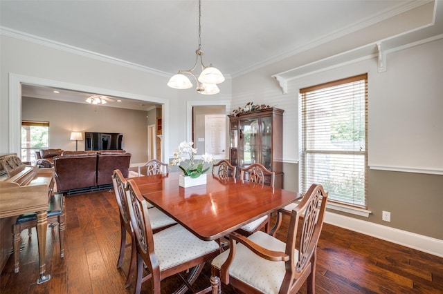 dining area featuring a notable chandelier, crown molding, baseboards, and dark wood-style flooring