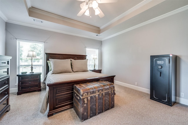 bedroom featuring multiple windows, visible vents, and a raised ceiling