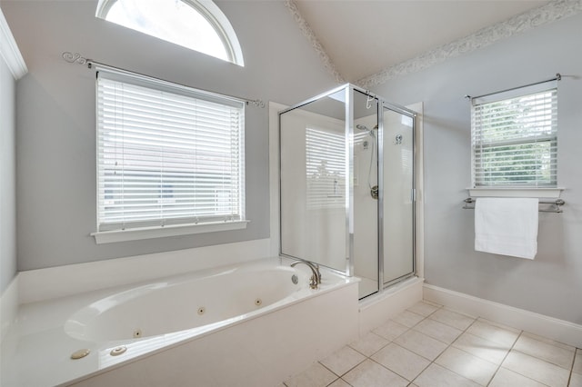 bathroom featuring baseboards, a tub with jets, a stall shower, and tile patterned floors