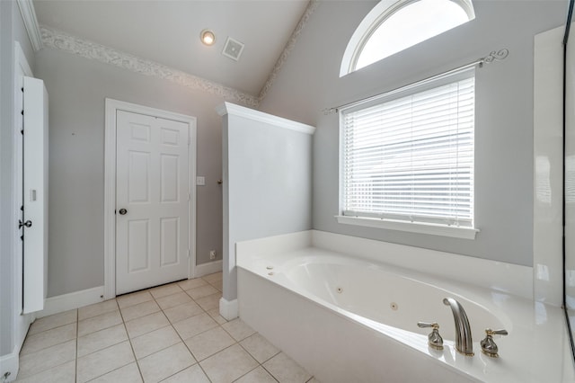 full bathroom with visible vents, vaulted ceiling, tile patterned flooring, a jetted tub, and baseboards