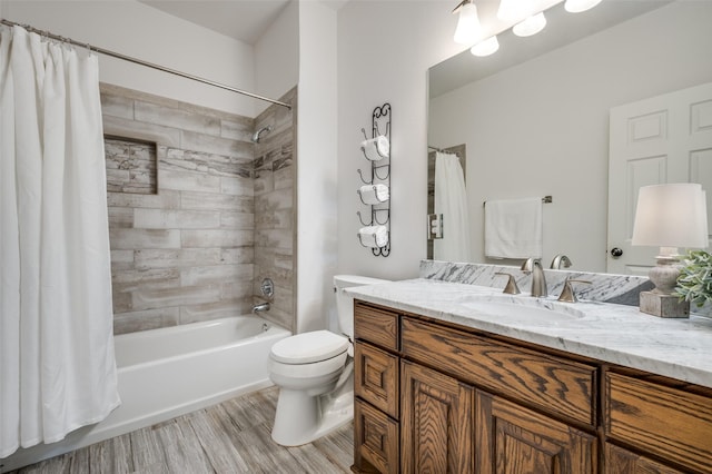 bathroom featuring toilet, shower / bath combo, wood finished floors, and vanity