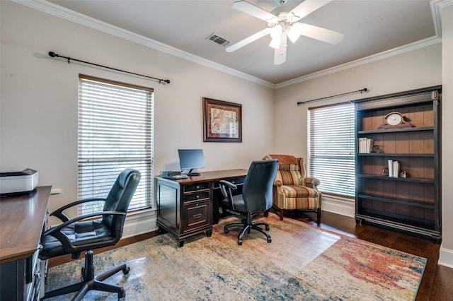 home office featuring baseboards, visible vents, a ceiling fan, ornamental molding, and wood finished floors