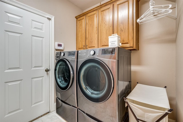 clothes washing area with cabinet space and separate washer and dryer