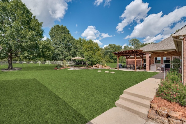 view of yard featuring fence, a pergola, and a patio