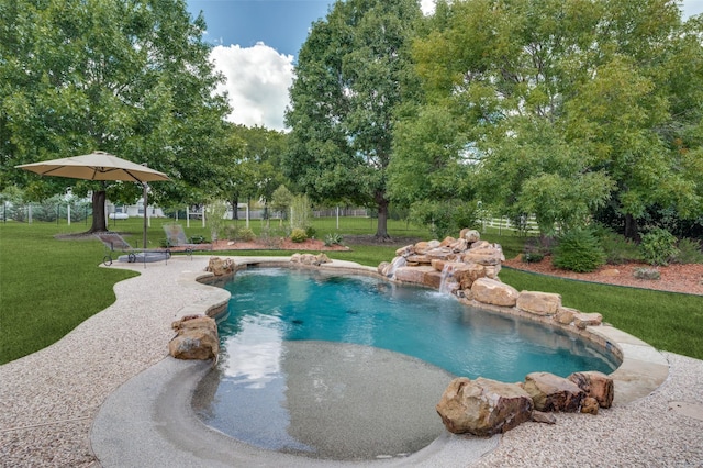 pool with a patio area, a yard, and fence