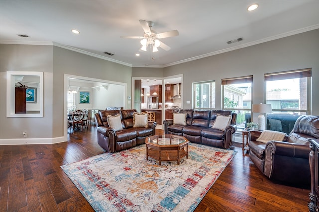 living area featuring crown molding, hardwood / wood-style floors, visible vents, and baseboards