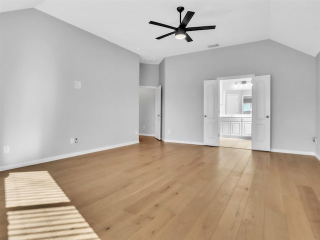 unfurnished living room with ceiling fan, visible vents, baseboards, vaulted ceiling, and light wood-style floors