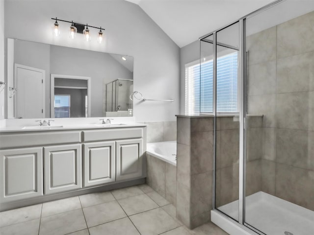 bathroom with lofted ceiling, a sink, a shower stall, tile patterned flooring, and a bath