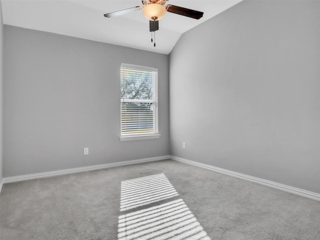 unfurnished room with lofted ceiling, a ceiling fan, baseboards, and carpet flooring