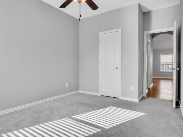 unfurnished bedroom featuring carpet flooring, ceiling fan, and baseboards