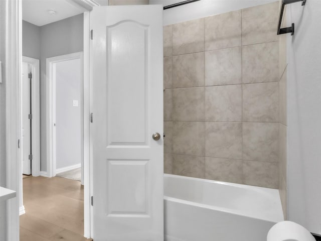 full bathroom featuring  shower combination and wood finished floors