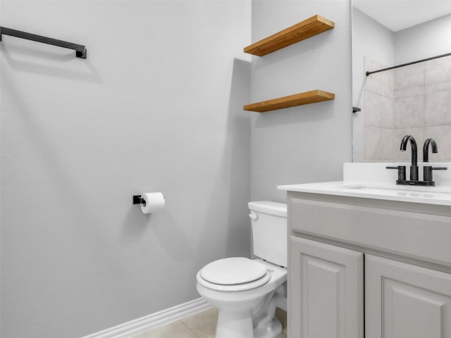 bathroom featuring baseboards, a shower, toilet, tile patterned flooring, and vanity