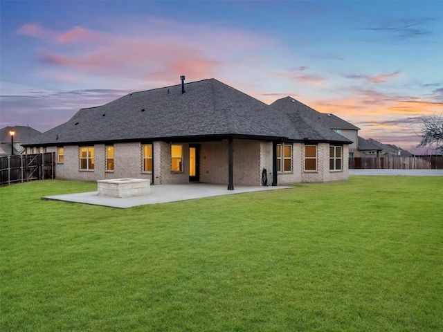 back of property with a yard, a fenced backyard, and a patio