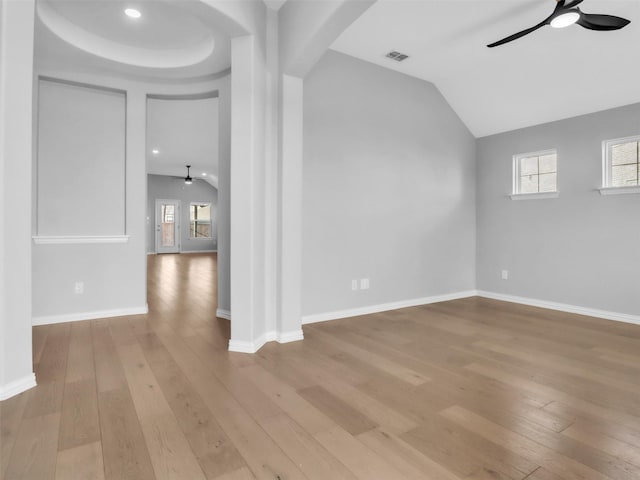 unfurnished room featuring ceiling fan, arched walkways, visible vents, and light wood-style floors