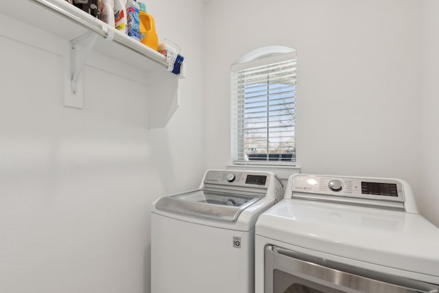 clothes washing area featuring washing machine and dryer and laundry area