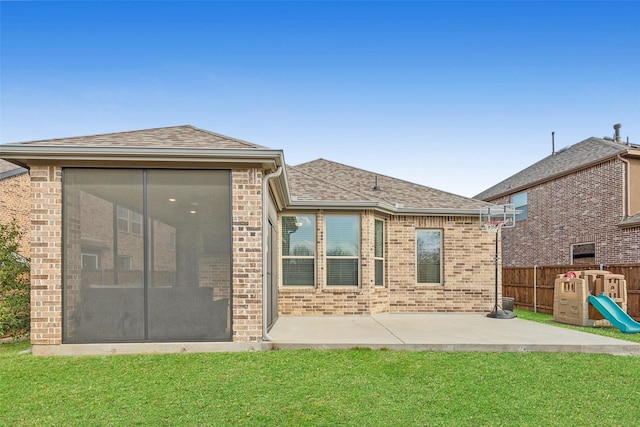 rear view of property with brick siding, a patio area, a playground, and a yard