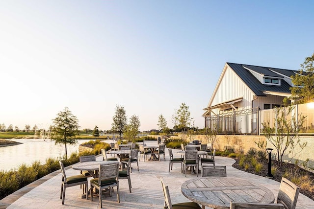 view of patio featuring outdoor dining area and a water view