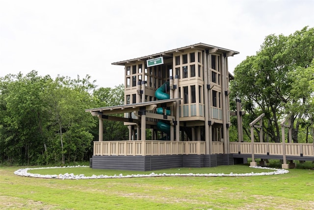 exterior space featuring playground community and a yard