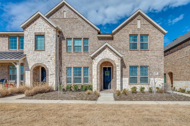 view of front of property with a front lawn and brick siding