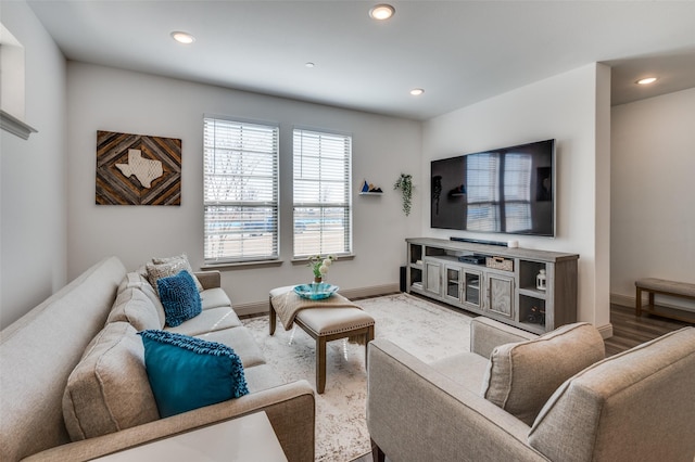 living area featuring baseboards, wood finished floors, and recessed lighting