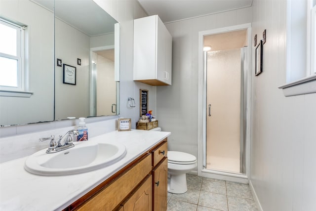 bathroom featuring tile patterned flooring, a shower stall, toilet, and vanity