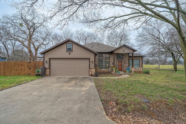 view of front of home with a garage, driveway, a front yard, and fence