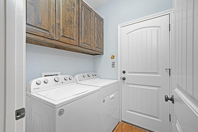 621 S Hill St, Pilot Point, TX 76258 - laundry room featuring washer and dryer, cabinet space, and light wood-style floors