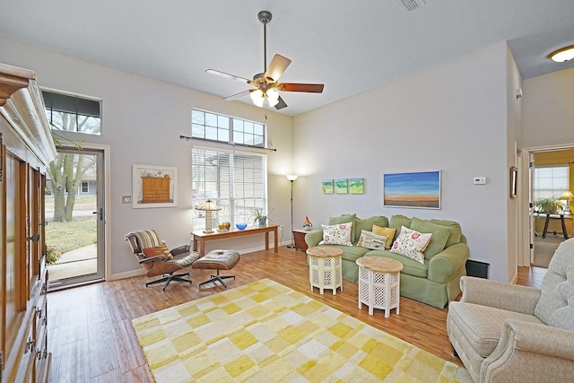 living area featuring wood finished floors and a towering ceiling