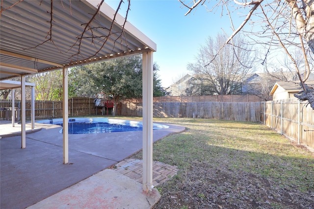 view of yard featuring a patio area, a fenced backyard, and a fenced in pool