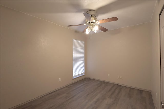 empty room featuring a ceiling fan and wood finished floors