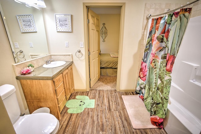 bathroom with vanity, toilet, and wood finished floors