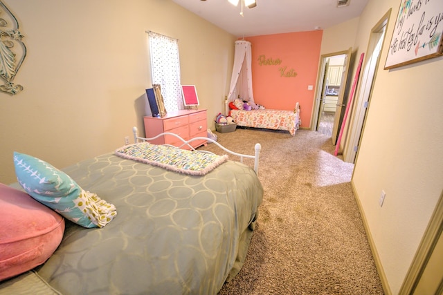 carpeted bedroom featuring visible vents, ceiling fan, and baseboards