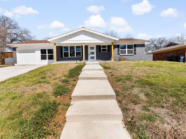 ranch-style home with driveway, an attached garage, a front lawn, board and batten siding, and brick siding