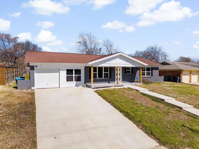 single story home featuring a garage, concrete driveway, fence, board and batten siding, and a front yard