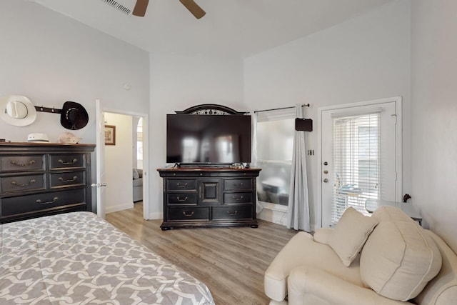211 Ember Glen Dr, Arlington, TX 76018 - bedroom featuring light wood-style flooring, baseboards, a ceiling fan, and a towering ceiling