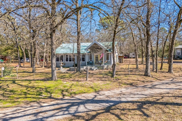 view of front of property featuring covered porch and metal roof