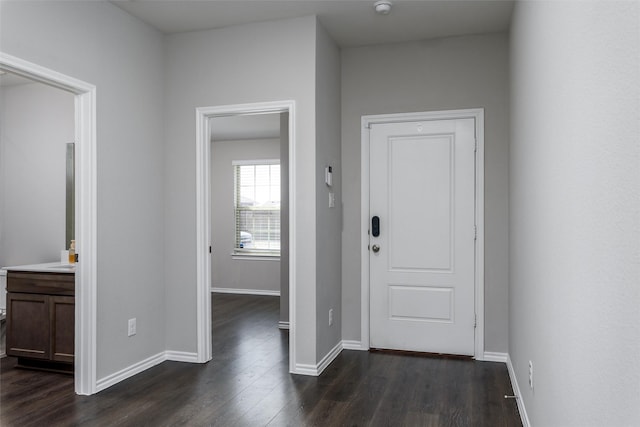 entrance foyer with dark wood finished floors and baseboards