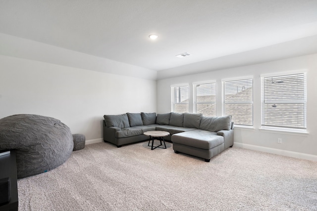 living room with carpet, visible vents, and baseboards