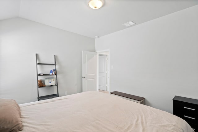 bedroom with lofted ceiling and visible vents