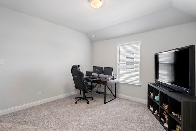 home office featuring lofted ceiling, baseboards, and carpet floors