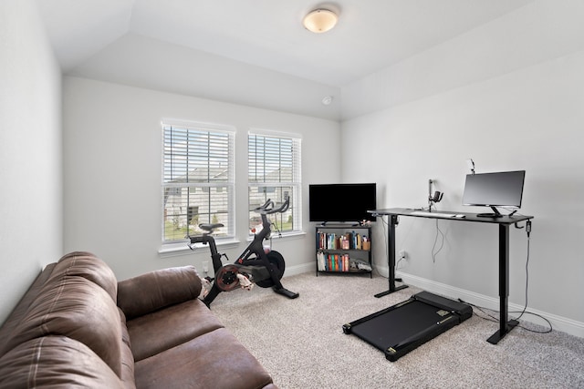 exercise area with carpet flooring, vaulted ceiling, and baseboards