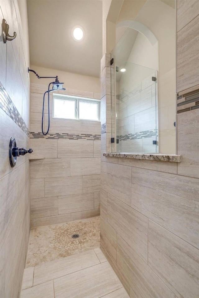 full bath with a tile shower