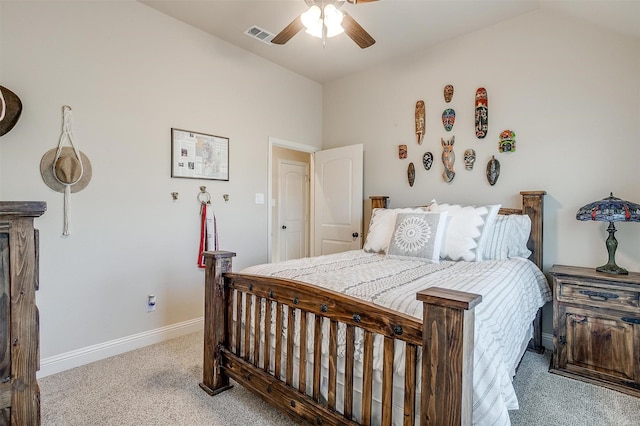 bedroom featuring carpet floors, visible vents, a ceiling fan, vaulted ceiling, and baseboards