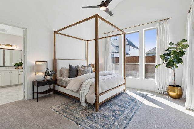 bedroom featuring ensuite bath, a ceiling fan, and light colored carpet