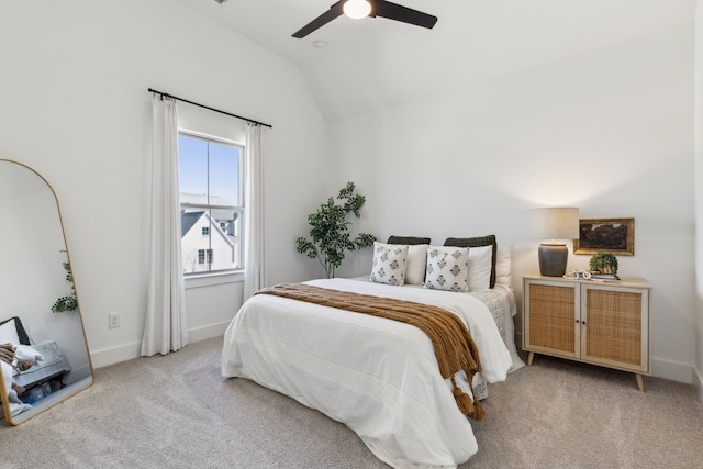 carpeted bedroom featuring a ceiling fan, vaulted ceiling, and baseboards