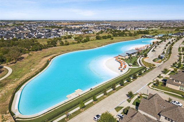 view of pool featuring a water view and a residential view